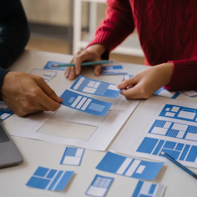 Two people collaborating on a mobile web design project